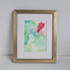 "Chloris Two, 2018" is an abstract alcohol ink painting featuring flowing, vibrant colors on Yupo paper, in a white mount and gold frame.