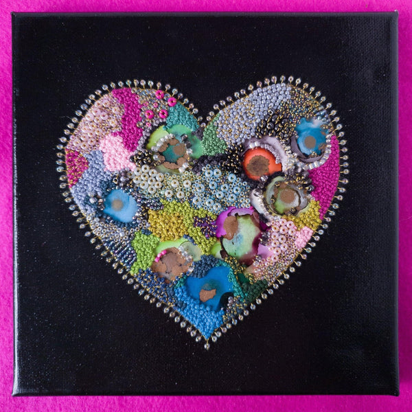 Abstract heart artwork with hand-embroidered beads and metallic threads, featuring alcohol ink on canvas.