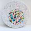 Abstract embroidered artwork with sequins, beads, and painted elements, showcasing detailed craftsmanship on canvas.