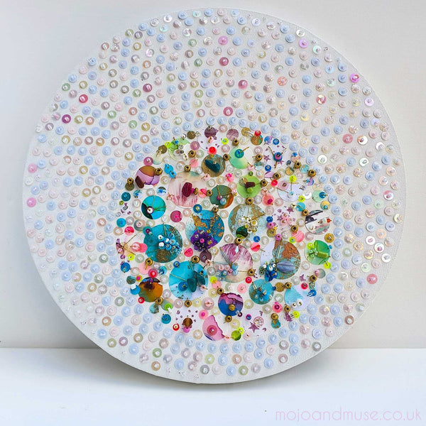 Abstract embroidered artwork with sequins, beads, and painted elements, showcasing detailed craftsmanship on canvas.