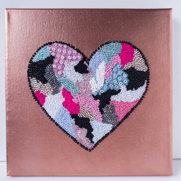 Abstract heart design with hand-embroidered threads, beads, and acrylic paint on canvas, from the Heart Series.