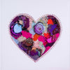 Abstract heart artwork with hand-embroidered metallic thread and beads, featuring alcohol ink details on canvas.