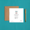 Square card back with colorful logo, artist information, and contact details beside a kraft envelope and gold pen on teal fabric