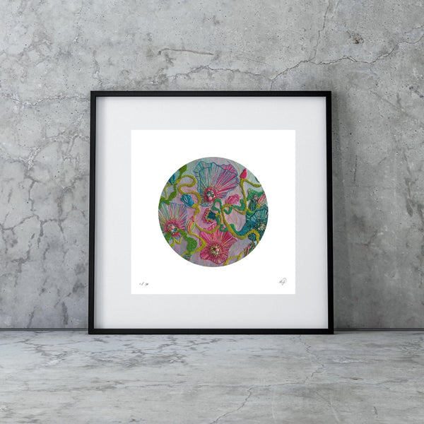 Framed abstract circular artwork with colorful swirling patterns leaning against a concrete wall on a polished floor.