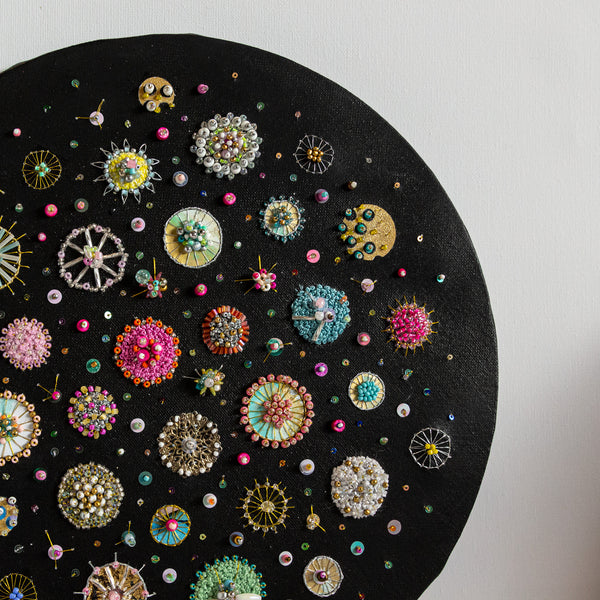 Black painted canvas, art work delicately hand stitched and embroidered with thread and salvaged beads and upcycled elements. Depicts diatoms, phytoplankton and zooplankton.