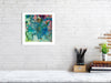 Framed Viola Five 2022 fine art print showing detailed abstract embroidery in vibrant blues and pinks on white wall.