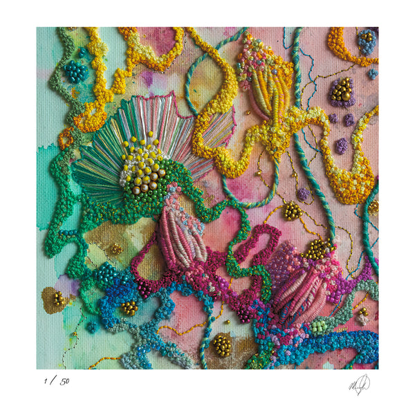 Close-up of colorful hand-stitched embroidery with textured threads and intricate beadwork on fabric.