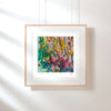 Framed Viola Five 2022 Giclée fine art print showing colorful embroidered textile details on white wall.