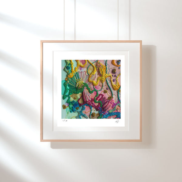 Framed Viola Five 2022 Giclée fine art print showing colorful embroidered textile details on white wall.