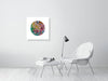 Modern minimalist living room with white chair and colorful Viola Five 2022 Mojo Worlds fine art print on wall