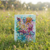 Colorful card with floral design on grass