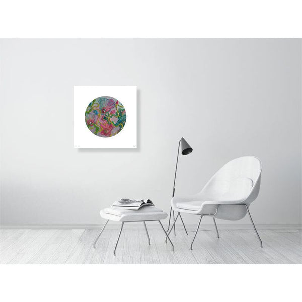 Minimalist modern room with white chair, matching ottoman with open magazine, black floor lamp, and colorful round wall art.