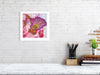 Framed Viola Odorata 2020 Giclée fine art print showing vibrant hand-stitched embroidery details on white wall.