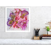 Abstract floral Viola Odorata 2020 Giclée fine art print with rich purples and pinks on white wall above desk.