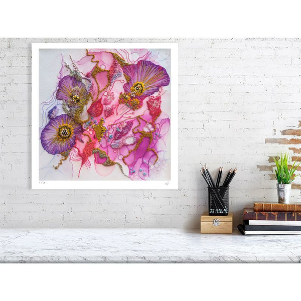 Abstract floral Viola Odorata 2020 Giclée fine art print with rich purples and pinks on white wall above desk.