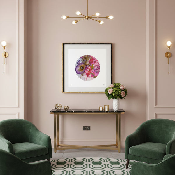 Framed Viola Odorata embroidery print with vibrant purple and pink floral textures in boutique hotel lobby space. The walls are pastel pink with green accented furniture and gold elements. 