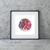 Framed abstract circular artwork by Manoela Grigorova with purple, gold, and pink shades leaning against a textured gray concrete wall.