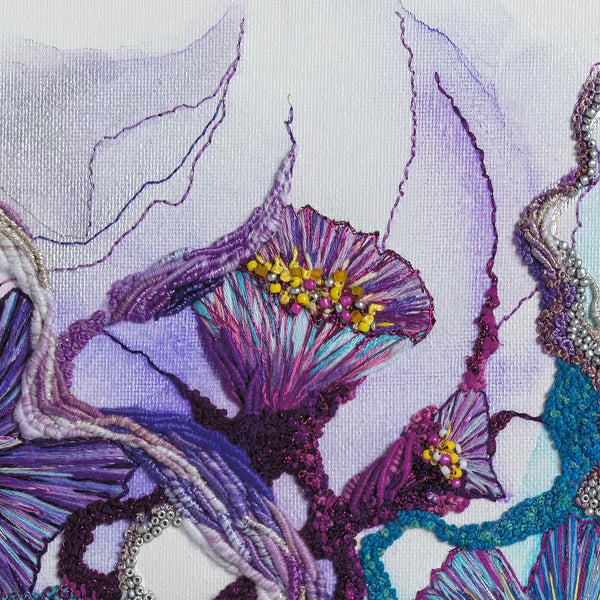 Close-up of colorful embroidered threads and beads on fabric showcasing texture and fine art detail from Viola Seven series.