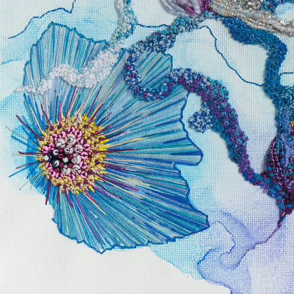 Close-up of hand-stitched blue and purple embroidery with bead details from Viola Seven 2023 fine art print.