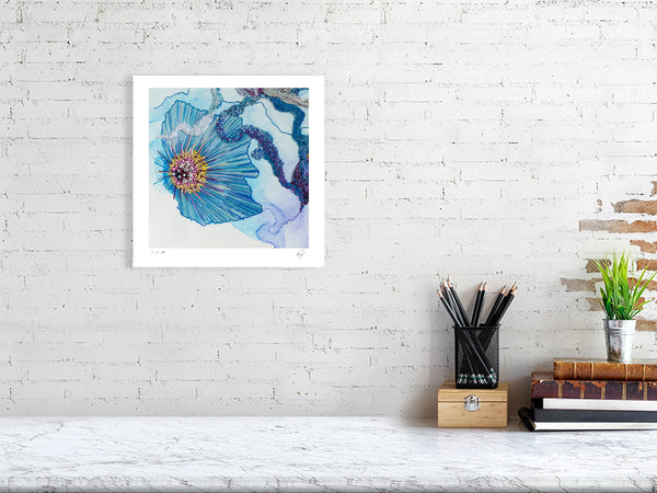 Framed Viola Seven 2023 Giclée fine art print showing detailed blue and purple embroidery on white wall above desk.