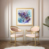Viola Seven 2023 abstract fine art print in gold frame hanging in elegant room with pink and gold chairs.