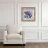 Ornate framed Viola Seven 2023 Giclée fine art print with abstract nature in blue and purple tones above beige armchair