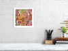 Viola Six 2022 Giclée Fine Art Print showing vibrant abstract embroidery details in warm tones framed on white wall.