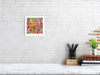 Viola Six 2022 Giclée fine art print showing vibrant abstract embroidery detail in a white frame on a white brick wall.