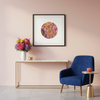 Modern interior with a blue armchair, marble console table, and floral arrangement against a pink wall. At the centre is a Viola Six, 2022, a reproduction of an embroidery artwork from Manoela Grigorova aka Mojo and Muse.