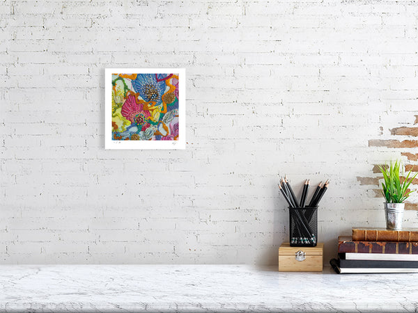 Viola Three 2022 detailed embroidery art print framed on white brick wall above minimalist desk setup
