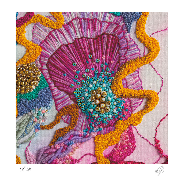 Close-up of vibrant hand-stitched embroidery with rich textures, golden beads, and colorful thread details.