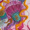 Close-up of Viola Three embroidery detail in vibrant pink, yellow, blue threads with intricate beadwork texture.