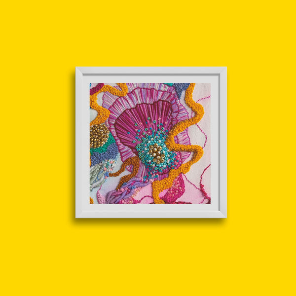 Framed Viola Three 2022 embroidery detail print in vibrant pink, orange, blue, and gold tones on yellow background.