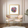 Framed Viola Three 2022 Mojo Worlds Giclée fine art print above two pink and gold chairs in a modern room