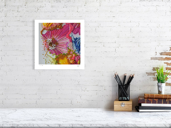 Framed Viola Two 2021 Giclée print showcasing colorful abstract embroidery details on white brick wall.