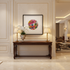 Decorative interior of a boutique hotel lobby with a wooden console table, floral arrangement, and framed print, Viola Two, from the limited edition print series, Mojo Worlds, by Manoela Grigorova, Mojo and Muse.