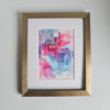 Abstract alcohol ink artwork in pink, purple, and blue tones on Yupo paper, mounted and framed in gold frame.