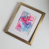 Abstract alcohol ink artwork with flowing pink, purple, and blue hues on Yupo paper in white mount.