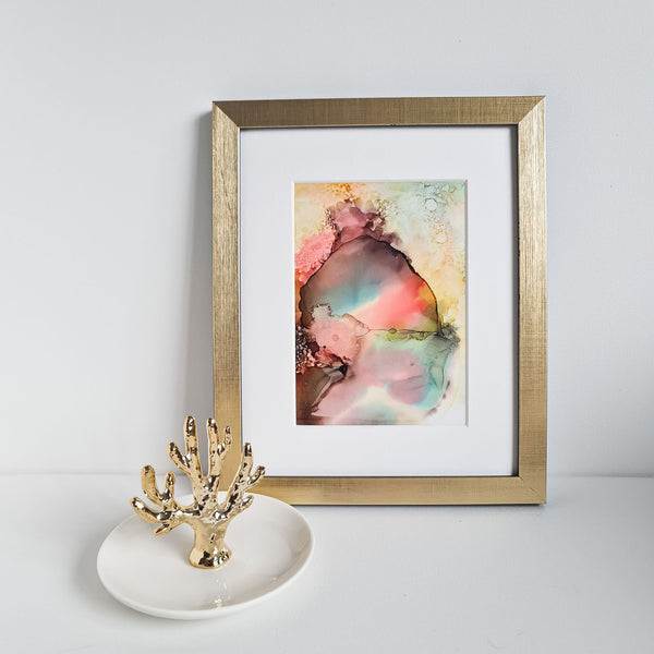 Abstract alcohol ink painting titled Ares One depicting Greek god of war, framed in gold and white mount.