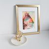 Abstract alcohol ink artwork titled Ares One depicting the Greek god of war, mounted in white with gold frame.