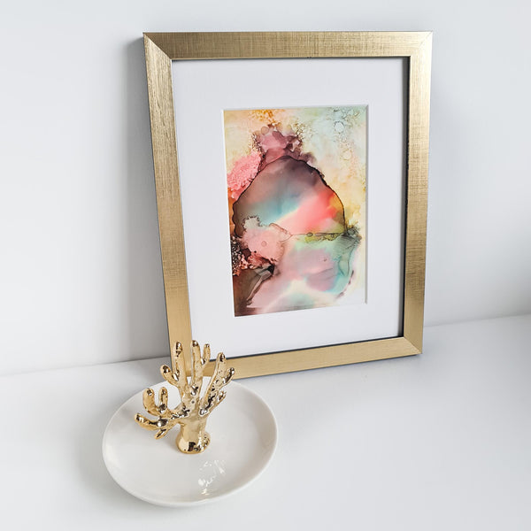 Abstract alcohol ink painting titled Ares One depicting the Greek god of war, mounted in a white mat with gold frame.