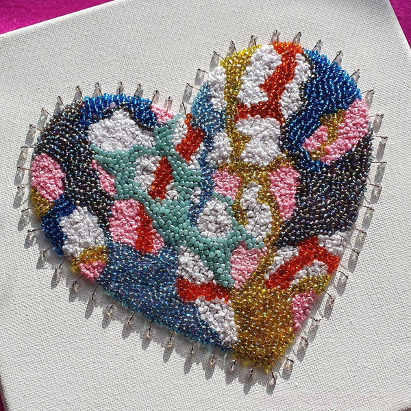Colorful heart-shaped embroidery with metallic threads and beads on canvas, part of the 2021 Heart Series art collection.