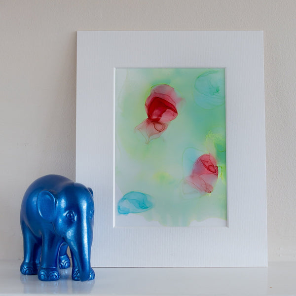 Abstract alcohol ink artwork titled Chloris One 2018 with red and blue floral shapes on a white mount.
