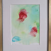 Abstract alcohol ink painting with flowing red, green, and blue shapes on pale green Yupo paper, mounted ready for framing
