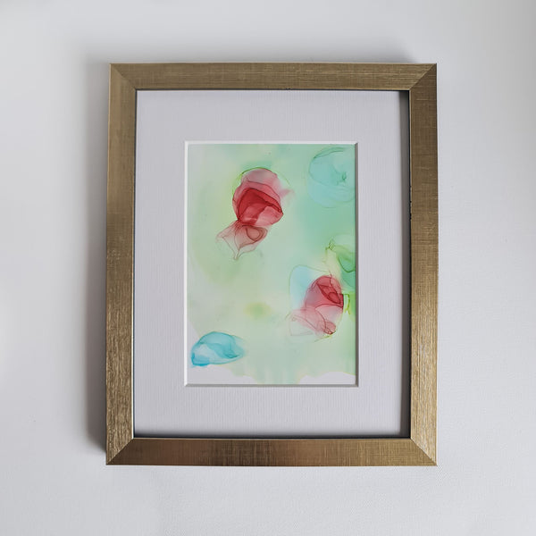 Abstract alcohol ink painting titled Chloris One, 2018, with soft red, blue, and green hues on Yupo paper in a gold frame.