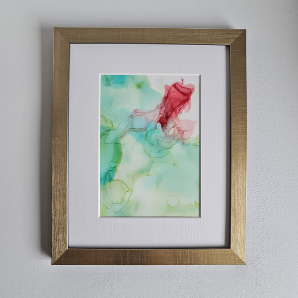 Abstract alcohol ink artwork titled Chloris Two, 2018, with soft green and red hues on Yupo paper in a gold frame.