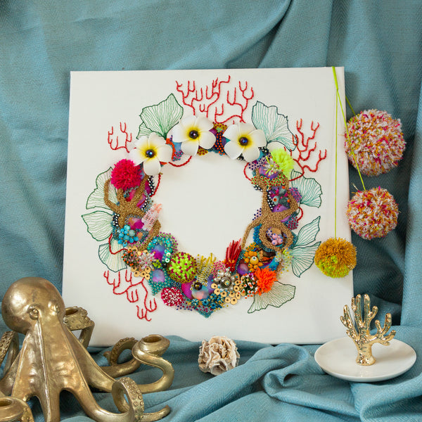 Abstract coral reef-inspired wreath artwork on square canvas with embroidery, beading, faux flowers, and gold metallic thread detailing