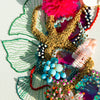 Close-up of Coral Wreath Nine artwork featuring embroidery, beads, faux flowers, and gold thread on canvas.
