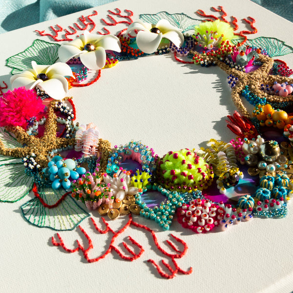 Abstract coral reef inspired wreath with beads, embroidery, faux flowers, and metallic thread on square canvas.
