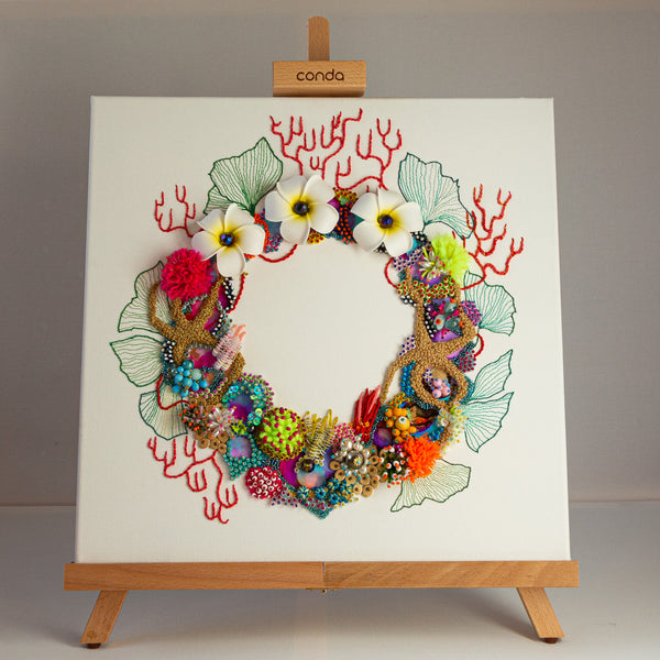 Square canvas artwork featuring a vibrant coral reef-inspired wreath with flowers, beads, and embroidery details